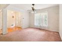 Inviting living room featuring large windows, carpeted floors, and a view of the front entryway at 885 Falling Water Ln, Norcross, GA 30093