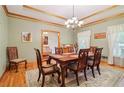 Elegant dining room featuring a wooden table, seating for six, and a decorative chandelier at 169 Robson Trl, Mcdonough, GA 30252