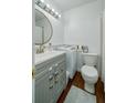 Functional bathroom featuring vanity, toilet, and convenient in-unit washer at 2805 Ne Expressway Ne # B 16, Atlanta, GA 30345