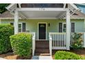 Inviting front porch with dark-stained wood and white railings, perfect for relaxing at 176 Rockyford Ne Rd, Atlanta, GA 30317