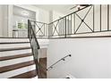 Staircase showcasing iron railing and contrasting wood and white finishes at 3611 Radcliffe Blvd, Decatur, GA 30034