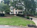 A view of the home from the street, showing the manicured lawn and mailbox along the driveway at 3641 Bramblewood Way, Marietta, GA 30062
