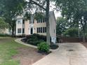 A view of the home from the side showing a long driveway and the two-car garage at 3641 Bramblewood Way, Marietta, GA 30062