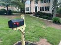 Well-manicured front yard with a lush green lawn and mailbox, presenting a welcoming entrance to the home at 3641 Bramblewood Way, Marietta, GA 30062