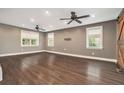 Spacious living room with hardwood floors, recessed lighting, fan, and three windows with natural light at 4141 Willow Ridge Rd, Douglasville, GA 30135