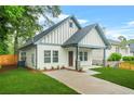 An inviting home exterior featuring a lush lawn, and a private driveway at 623 Hamilton E Holmes Nw Dr, Atlanta, GA 30318