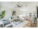 Bright living room with high ceilings, neutral furnishings, a modern ceiling fan, and a stylish rug at 623 Hamilton E Holmes Nw Dr, Atlanta, GA 30318