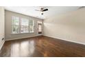 Spacious living room filled with natural light, featuring hardwood floors and a ceiling fan at 1343 Penhurst Dr, Lawrenceville, GA 30043