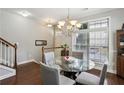 Cozy dining room with a round glass table, stylish chairs, and natural light from a large window at 7275 Highland Blf # 8, Atlanta, GA 30328