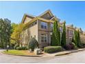 Beautiful exterior of a townhome featuring manicured greenery and a view of the surrounding landscape at 7275 Highland Blf # 8, Atlanta, GA 30328