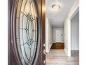 Inviting entryway showcasing a decorative glass front door, leading into a home with light-colored walls and flooring at 1181 Mannbrook Dr, Stone Mountain, GA 30083