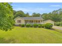 Well-maintained lawn, lush manicured shrubbery and inviting front porch on this charming home with a detached garage at 3100 Meadow Trl, Loganville, GA 30052