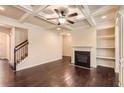 Spacious living room featuring hardwood floors, fireplace, and coffered ceilings at 3280 Hallmark Ln, Buford, GA 30519