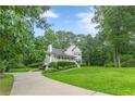 Well-maintained home with lush lawn and a driveway, surrounded by mature trees and landscaping at 5609 Twin Oak Dr, Douglasville, GA 30135