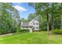 Traditional two-story home with a welcoming front porch and beautiful green lawn surrounded by mature trees at 5609 Twin Oak Dr, Douglasville, GA 30135