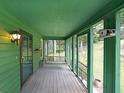 View of a cozy screened porch with a swing, painted in shades of green, perfect for relaxing outdoors at 3743 Wyntuck Nw Cir, Kennesaw, GA 30152