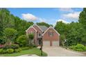 Charming two-story brick home with well-manicured lawn and mature trees at 4987 Day Lily Nw Way, Acworth, GA 30102