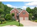 Charming two-story brick home with well-manicured lawn and mature trees at 4987 Day Lily Nw Way, Acworth, GA 30102