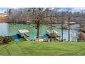Picturesque view of the lake with private docks, enhancing the waterfront living experience at 6313 Shoreland Cir, Buford, GA 30518