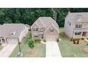 Expansive aerial view of a brick home with a well-manicured lawn, long driveway and mature trees at 2870 Prestwood Dr, Cumming, GA 30040