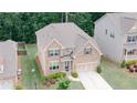 Aerial view of a well-maintained brick home featuring an inviting entrance, long driveway, and mature trees at 2870 Prestwood Dr, Cumming, GA 30040