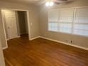 Comfortable bedroom showcasing hardwood floors, ceiling fan, and ample natural light at 4902 Pine Hill E Ct, Stone Mountain, GA 30088