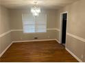 Elegant dining room with hardwood floors and stylish chandelier at 4902 Pine Hill E Ct, Stone Mountain, GA 30088