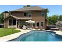 Relaxing backyard with a private pool, patio seating, and a hot tub, perfect for outdoor entertaining and leisure at 8340 Nolandwood Ln, Villa Rica, GA 30180