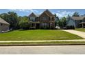 Traditional two-story home with a well-kept lawn, offering classic curb appeal in a friendly neighborhood setting at 8340 Nolandwood Ln, Villa Rica, GA 30180