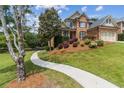 Beautiful brick home featuring a well-manicured lawn, shrubbery, and sidewalk at 1408 Chloe Dr, Lawrenceville, GA 30043