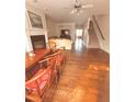 Open-concept living space with hardwood floors, fireplace, and ample natural light at 4438 Lassen Ct, Suwanee, GA 30024