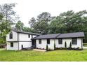 Charming two-story home featuring white brick and siding with a well-manicured lawn at 69 N Hearn Rd, Ellenwood, GA 30294