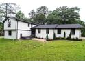 Charming two-story home featuring white brick and siding with a well-manicured lawn at 69 N Hearn Rd, Ellenwood, GA 30294