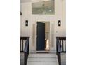 Striking front entrance with a contemporary door, side lights, overhead transom, and stylish exterior lighting at 974 Clydesdale Dr, Marietta, GA 30062