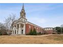 Stunning exterior view of church conversion with grand entrance and mature landscaping on an expansive lot at 1200 Ponce De Leon Ne Ave # A1, Atlanta, GA 30306