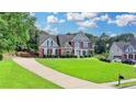 Beautiful two-story home with a large front yard and an extended driveway at 189 Azalea Chase Dr, Suwanee, GA 30024