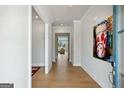 Bright entryway featuring hardwood floors, a modern art piece, and an open view into the living area at 247 Widener Way, Peachtree City, GA 30269