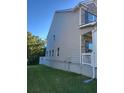 Side view of a two-story home featuring neutral siding and manicured lawn at 3675 Brookhollow Dr, Douglasville, GA 30135