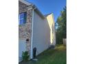 Side of home shows neutral siding and brick accents, adjacent to green lawn at 3675 Brookhollow Dr, Douglasville, GA 30135