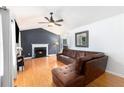Spacious living room with hardwood floors, fireplace, and a comfortable leather sectional at 1902 Seals Rd, Dallas, GA 30157