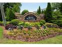 Attractive community entrance with stone signage and lush landscaping at Lenox Crossing at 2305 Limehurst Ne Dr # 21, Atlanta, GA 30319