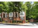 Beautiful townhouse showcasing brick facade, symmetrical windows, covered entryways and landscaped grounds at 2305 Limehurst Ne Dr # 21, Atlanta, GA 30319