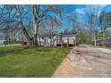 Charming home exterior with a large tree in the yard and a driveway leading to the property at 5153 Westbrook Pl, Union City, GA 30291