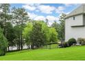 Well-maintained backyard with a lush green lawn and tree line on a sunny day at 5755 Riley Rd, Cumming, GA 30028
