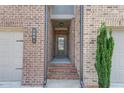 Inviting front entrance with brick steps leading to a glass-paneled front door of a townhome at 2005 Hamilton Creek Pkwy, Dacula, GA 30019