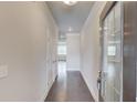 Entry hallway with hardwood floors and white walls, offering a glimpse into the bright living spaces at 2005 Hamilton Creek Pkwy, Dacula, GA 30019