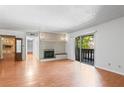 Bright living room features a fireplace, hardwood floors and sliding doors that leads to a patio at 1308 Camelot Dr, Atlanta, GA 30349