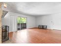 Spacious living room featuring beautiful floors, a cozy fireplace, and ample natural light at 1308 Camelot Dr, Atlanta, GA 30349
