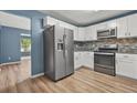 Spacious kitchen boasts stainless steel refrigerator and appliances with ample countertop space at 4753 Klondike Cv, Lithonia, GA 30038