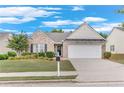 Inviting single-Gathering home with a brick and siding exterior, neat landscaping, and a two-car garage at 936 Village View Cir, Loganville, GA 30052